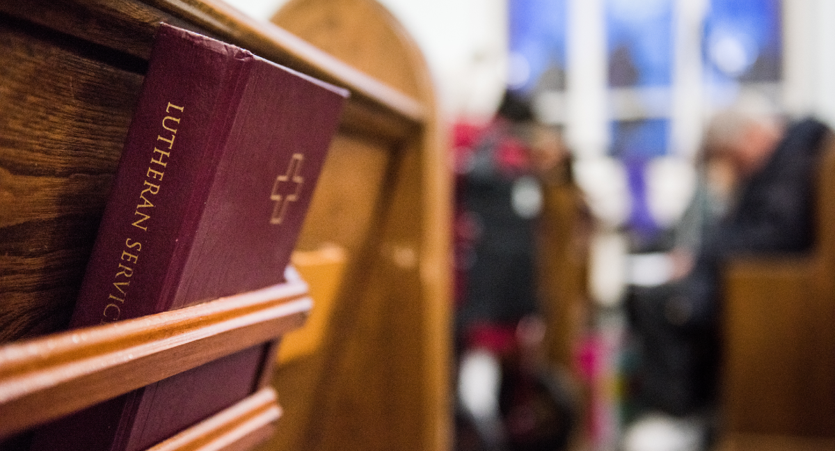 'Lutheran Service Book" hymnal sits in a church pew rack.